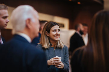 a female law student chats with others outside of the auditorium 