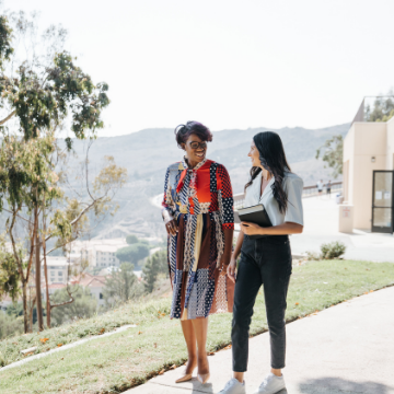 Dean Chalak Richards walks with a student outside