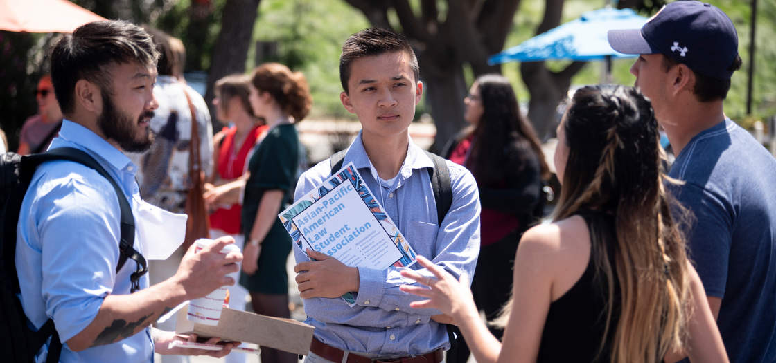 four students talking at a student organization fair